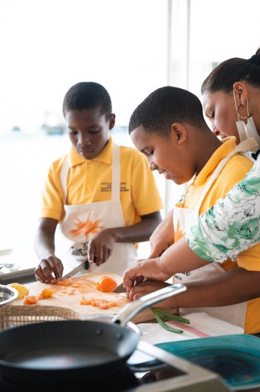 children cooking together at outdoor workshop