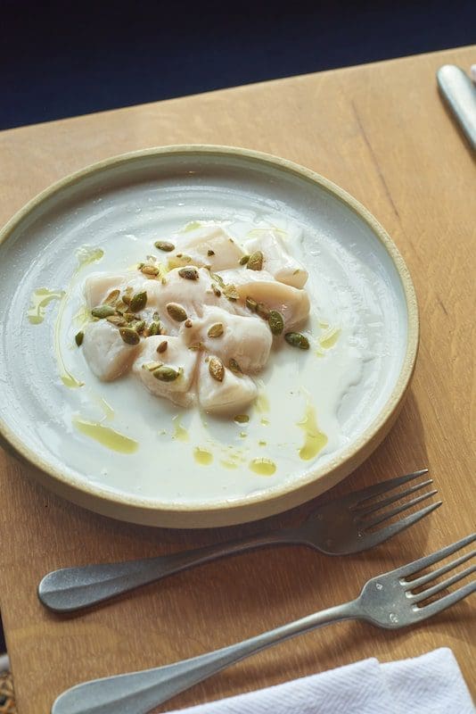 Scallop Crudo on rustic plate