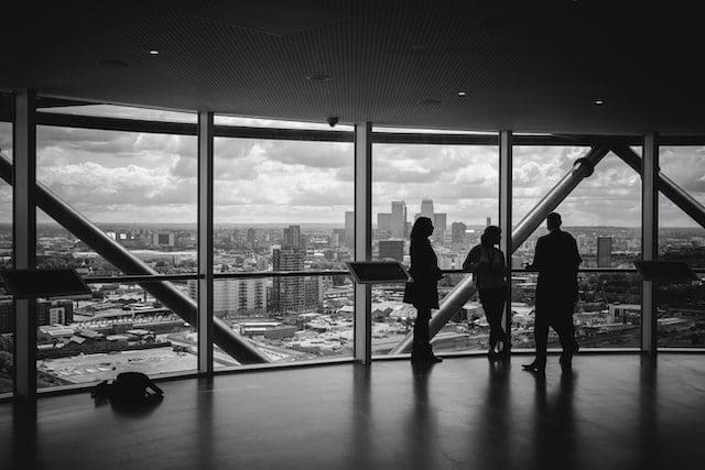 meeting near a transparent glass black and white photo