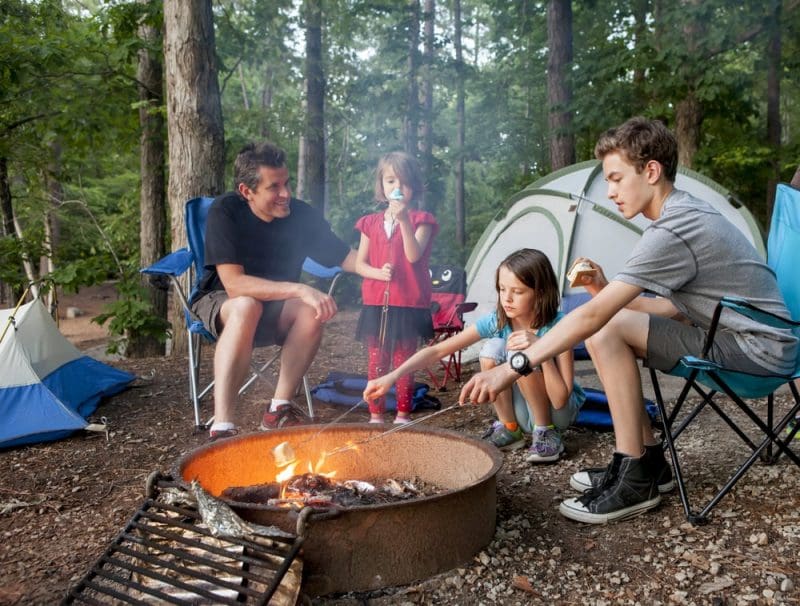 father camping and cooking with kids