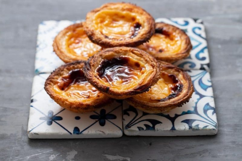 Typical portuguese egg tart pastel de nata on ceramic background