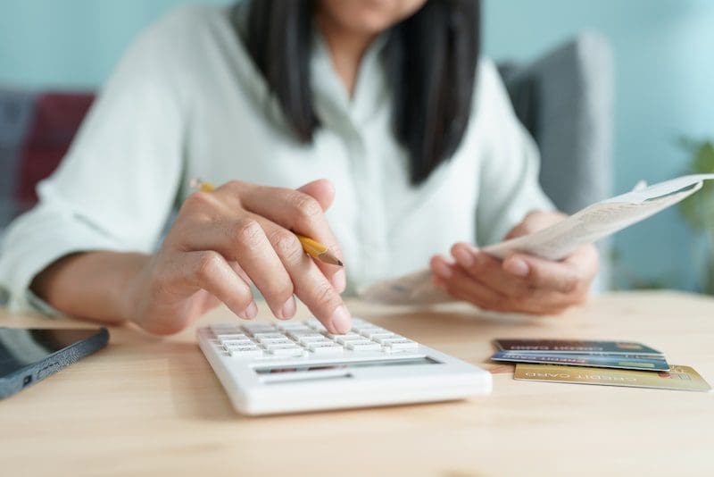 Hand of Asian woman are calculating costs and payments