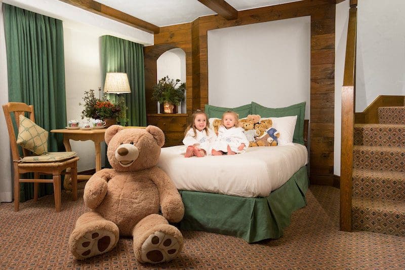 The Sonnenalp Ski Resort for families girls on bed teddy bear