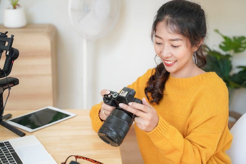 Lifestyle Asia young women photographer and freelance holding camera-min