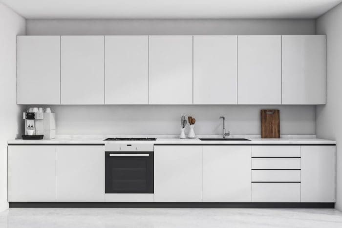 New modern all-white kitchen with simple cabinets and narrow drawers