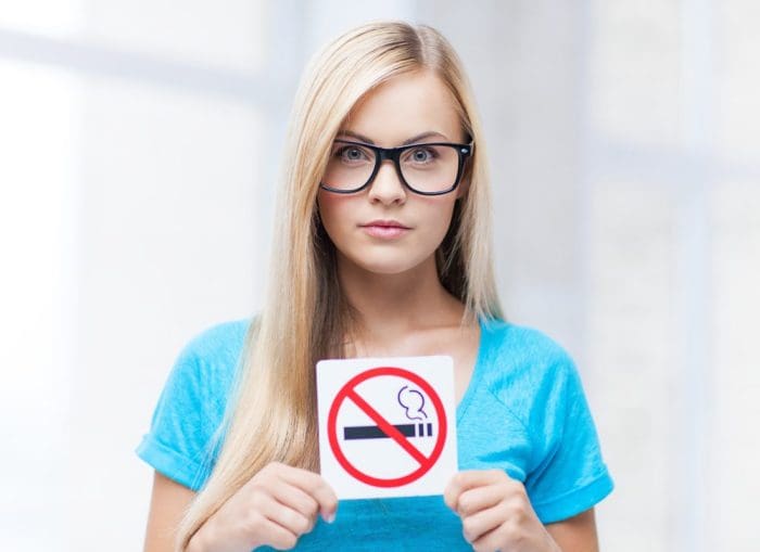 picture of woman with smoking restriction sign