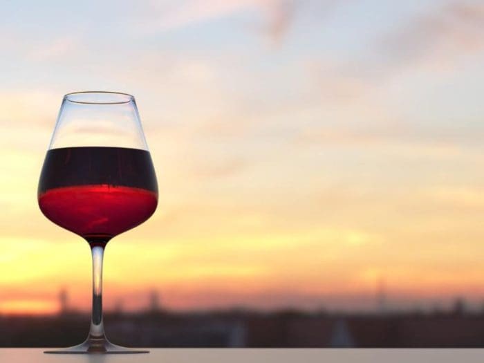 red wine glass with sunset background