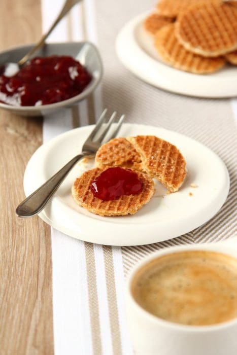 Mini stroopwafels (syrupwaffles) with cup of coffee and jam