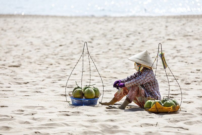 Vietnamese woman selling Fruits at Mui Ne beach
