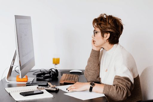 woman with short hair working at computer