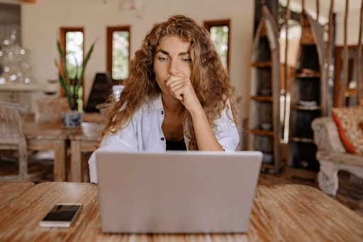 woman working at computer at home brown hair tan skin
