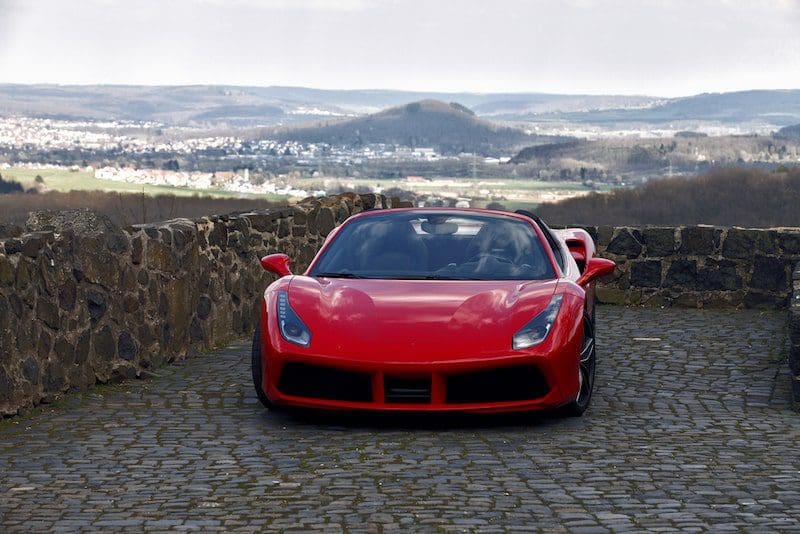 red sports car parked on top of hill
