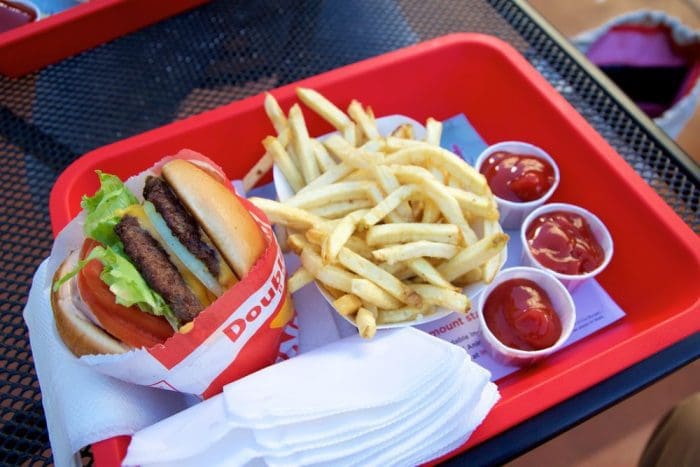 In n Out Double Double cheeseburger with animal style, burger with protein style, and french fries in a tray