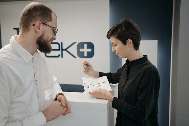 two employees working together reviewing graphic work