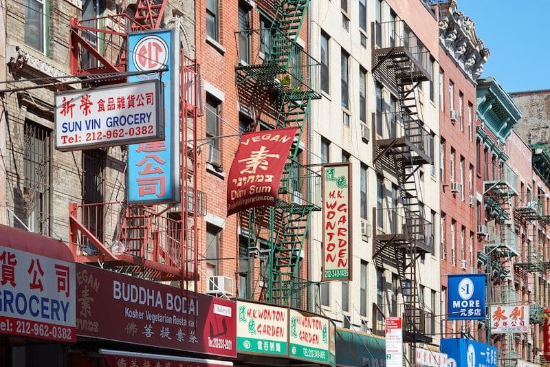 Chinatown street with building facades with signs in New York