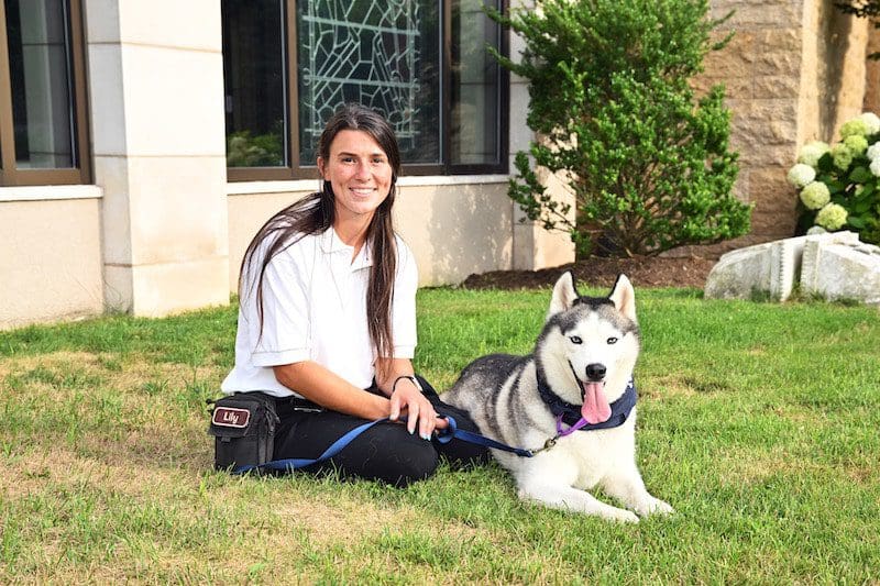 young woman with husky animal shelter