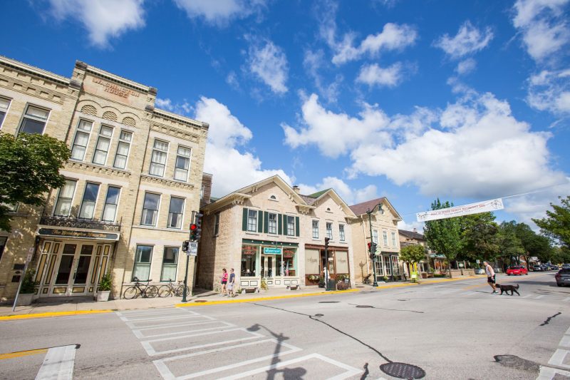 Man and Dog Crossing Street Downtown Cedarburg-min