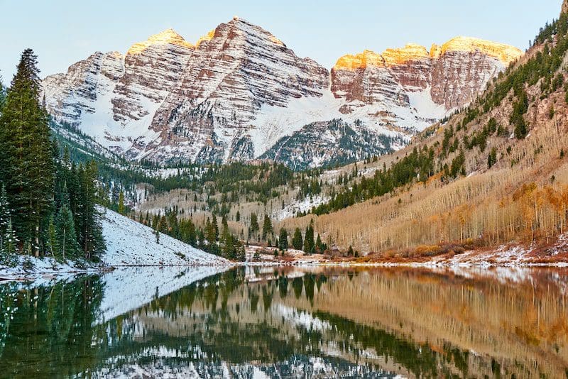 Maroon Bells and Maroon Lake with reflection of rocks and mountains