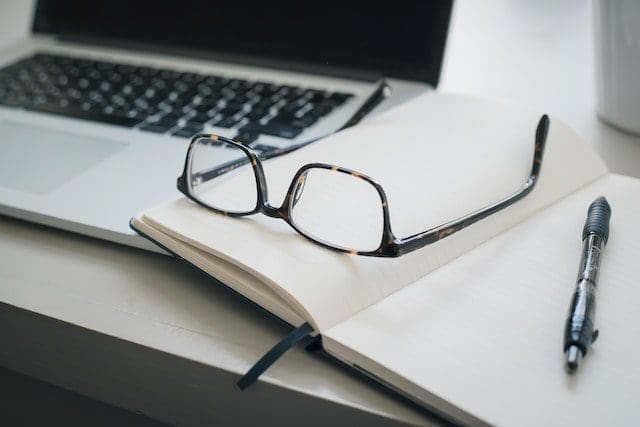 black framed eyeglasses and black pen-min