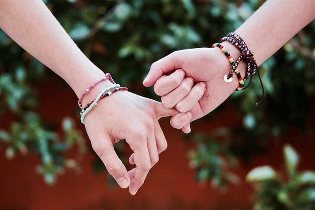 friendship bracelets hand holding