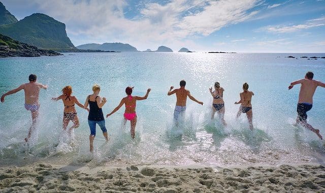 group of people playing on beach Norway
