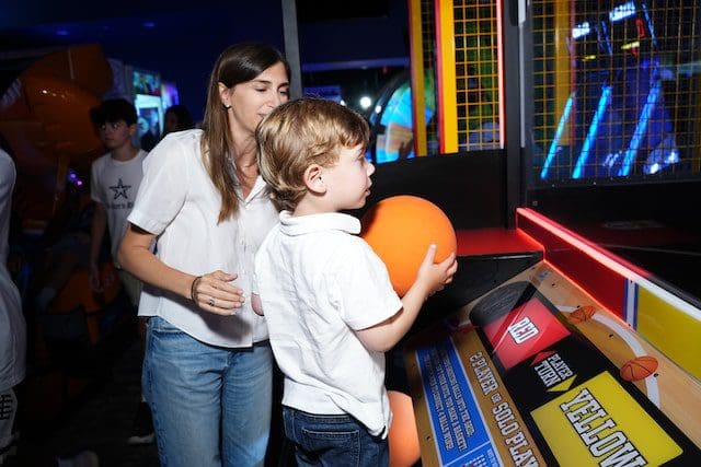 boy and mom playing in indoor arcade Hamptons