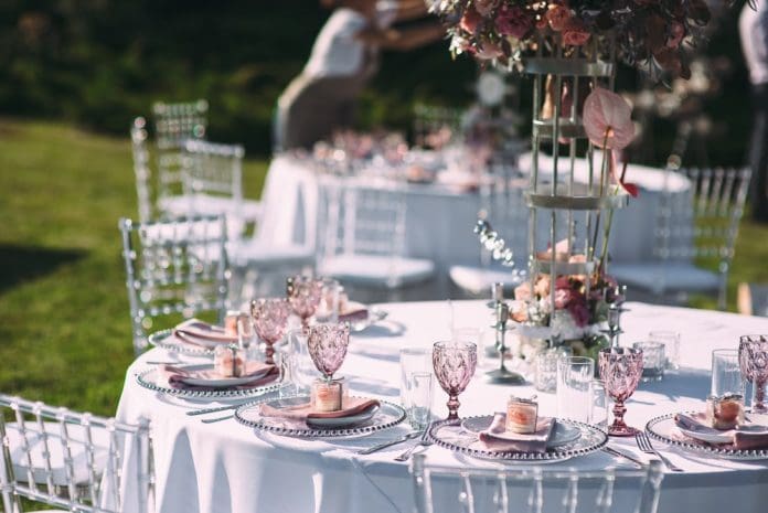 Banquet table on a green lawn. Racks and cutlery, velvet