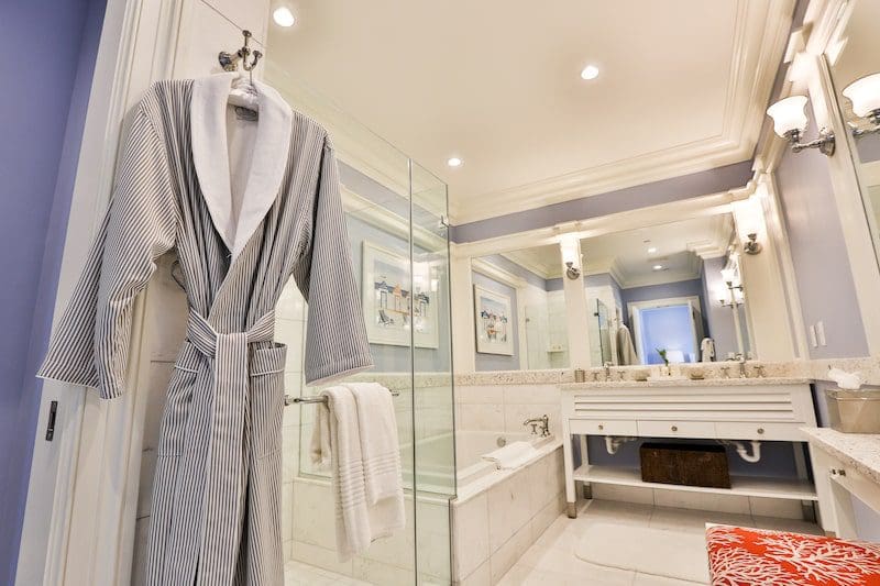 robe hanging on shower in hotel room