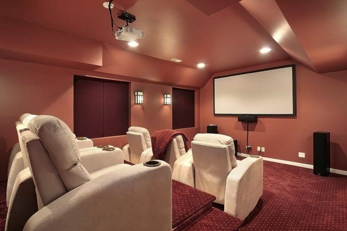 home theater with red walls and carpet