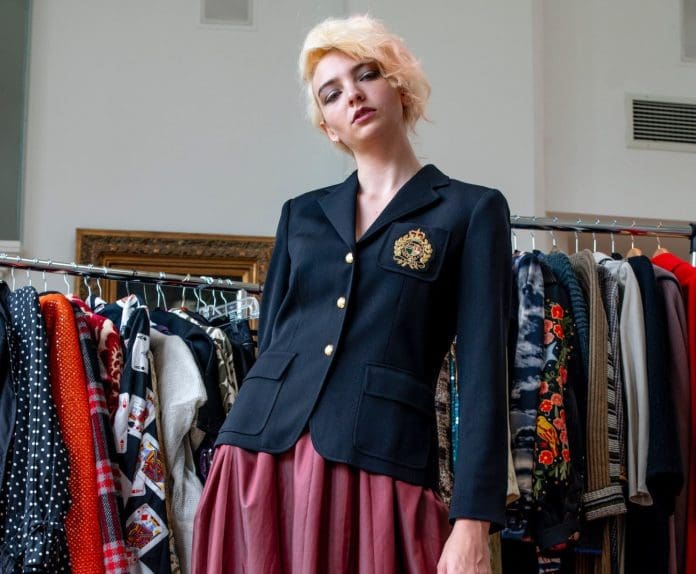 woman with blonde hair navy blazer jacket maroon skirt