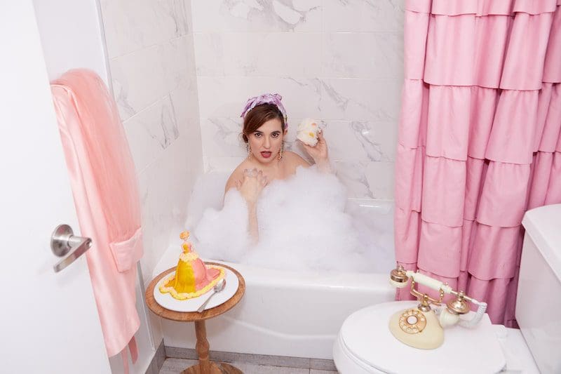 woman in bathtub with cake pink pretty fun