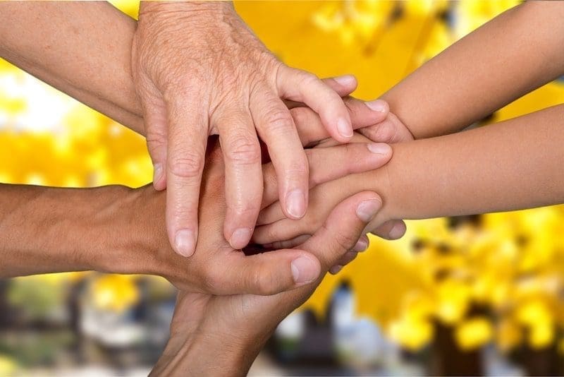 Family holding their hands together