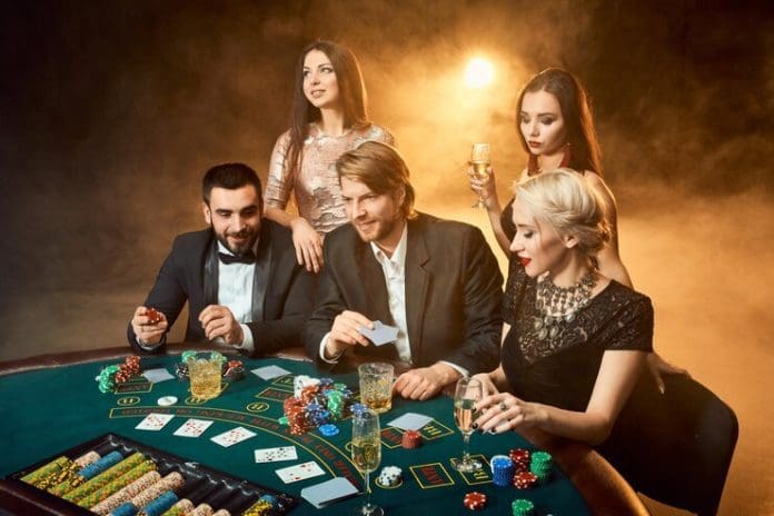 poker players sitting around table casino poker gambling