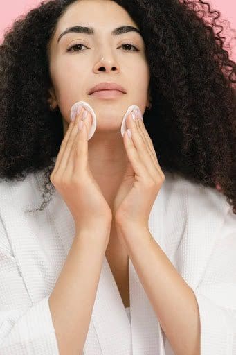 woman using makeup remover pads