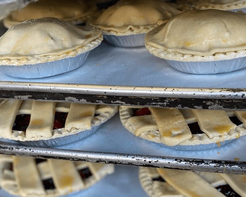 apple pies on racks baking in oven