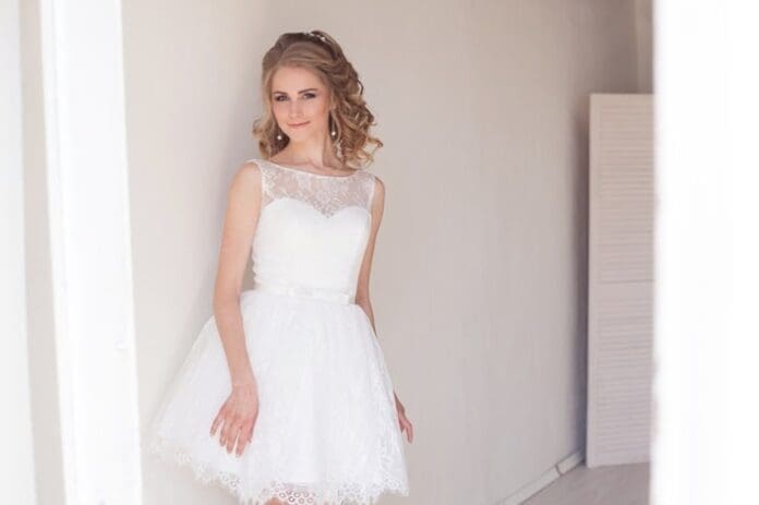 Pretty girl in a short white wedding dress