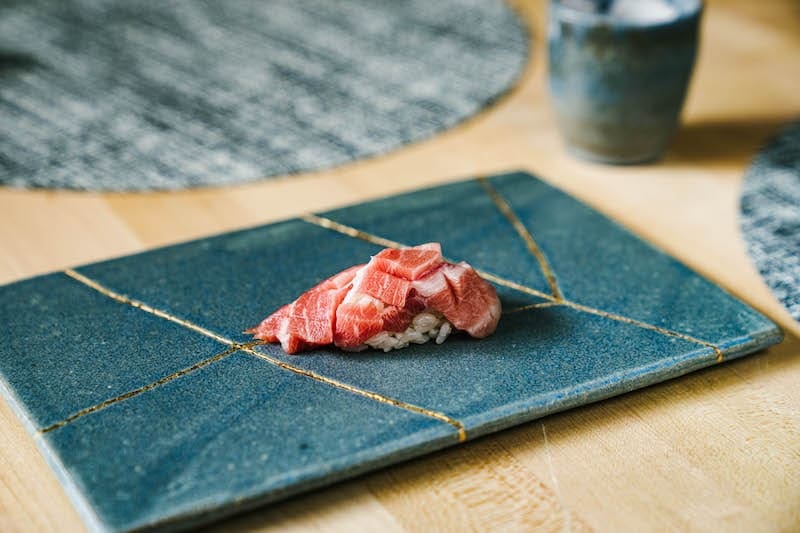 Toro sushi omakase on blue plate