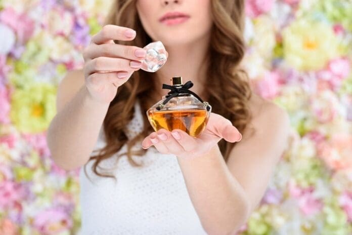 cropped-shot-of-woman-opening-bottle-of-perfume