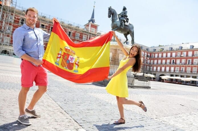 man and woman holding Spanish flag Madrid
