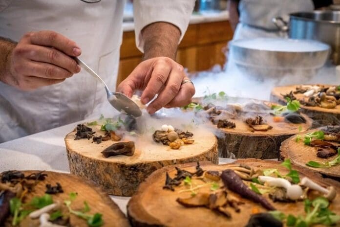 chef preparing elaborate meal in lux restaurant