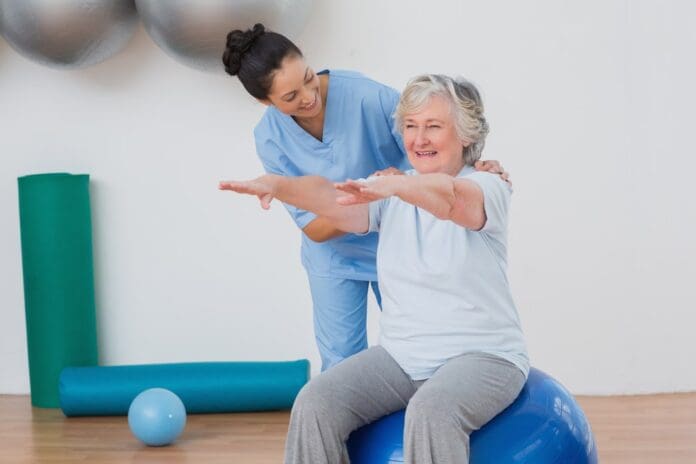 woman physical therapist working with woman patient
