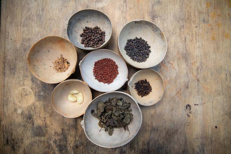 traditional mayan spices in bowls on wood table