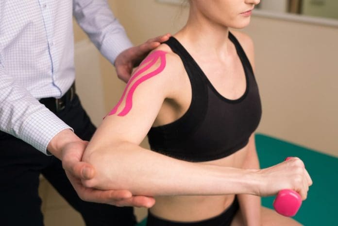 Physiotherapist doing shoulder exercise