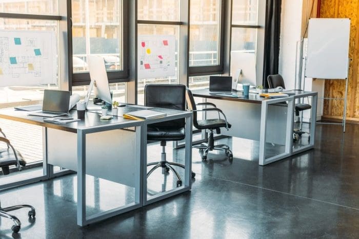 Working tables with computers and laptops in business office