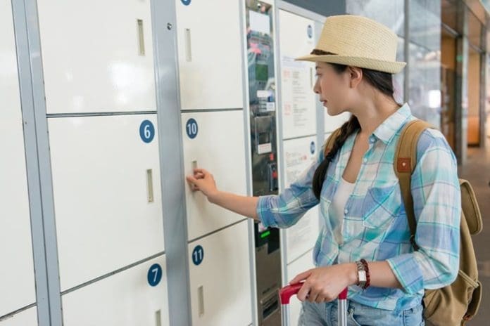 Young travel woman using the locker
