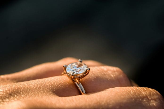engagement ring hand black background