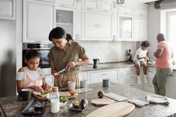 family cooking together in the kitchen white decor