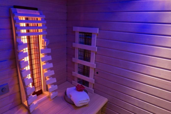 Private indoor infrared sauna with towel and flower