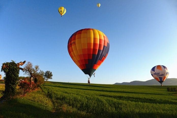 Hot air balloon landing on grass