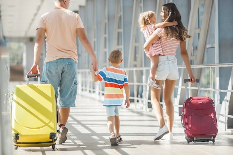 Happy family in airport departures. People in terminal preparing for the vacation